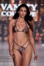 Aaliyah Cheeky Bikini Bottom with Gold Chains in Leopard Print from Vanity Couture, featuring a bold leopard print design, cheeky cut, and luxurious gold chain accents.